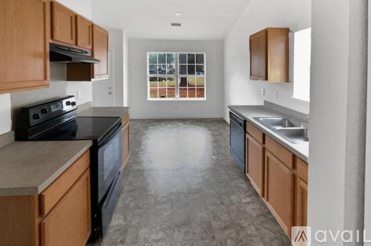 A kitchen with wooden cabinets and a black stove top oven.