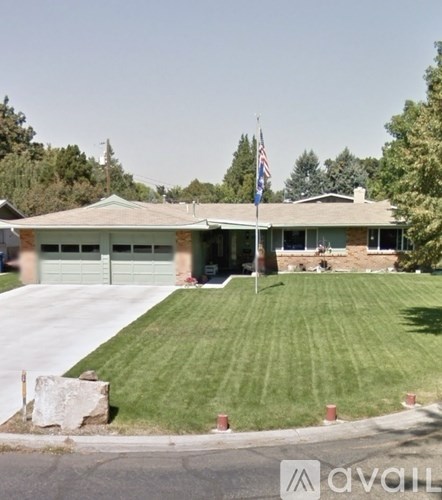 A house with a green lawn and a flag on the front.
