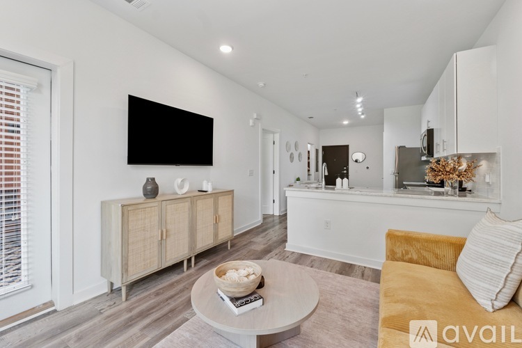 A modern living room with a flat screen TV mounted on the wall.