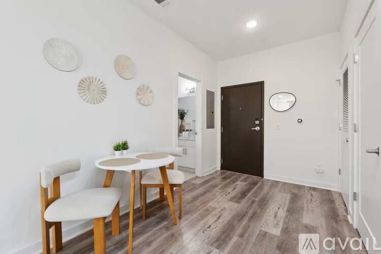 A dining area with a white table and chairs.