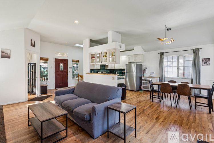 A living room with a grey couch and a wooden coffee table.