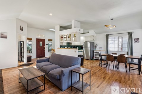 A living room with a grey couch and a wooden coffee table.