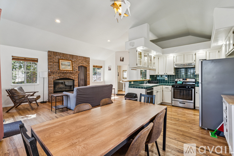 A modern kitchen with a wooden table and chairs.
