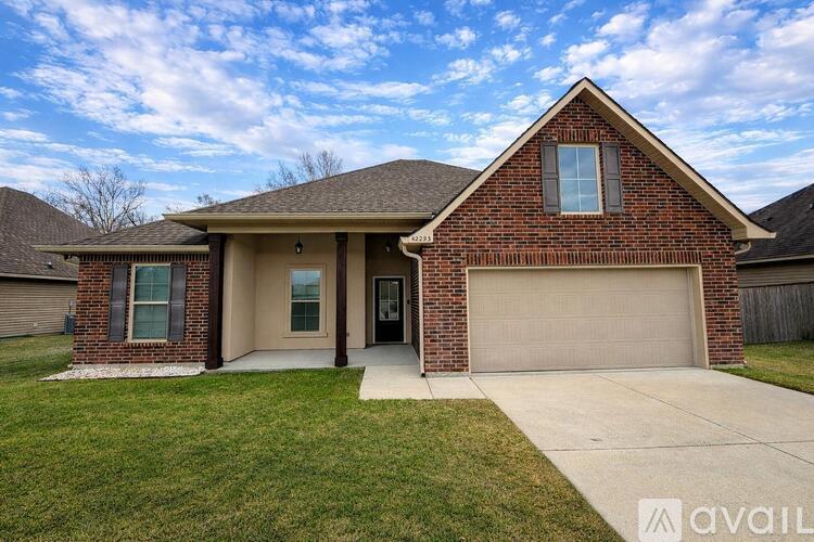 A brick house with a garage door and a window.