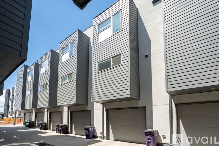A series of modern buildings with garage doors and windows.
