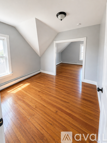A room with wooden floors and a white door.
