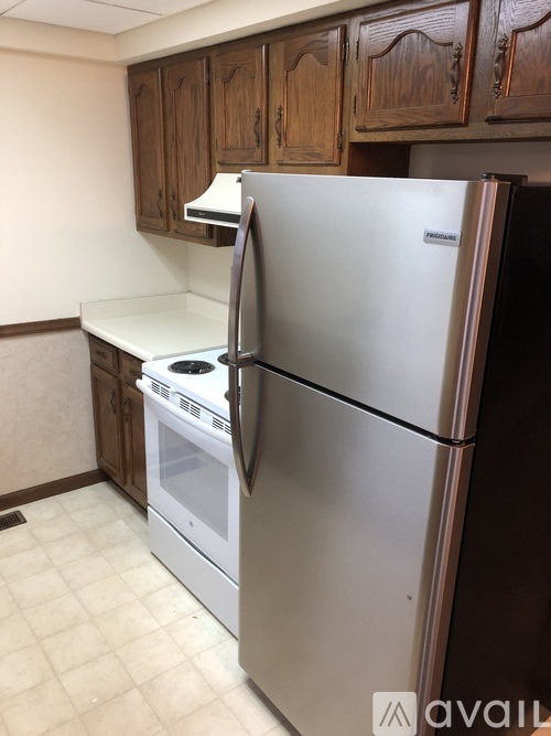 A kitchen with a stainless steel refrigerator and oven.