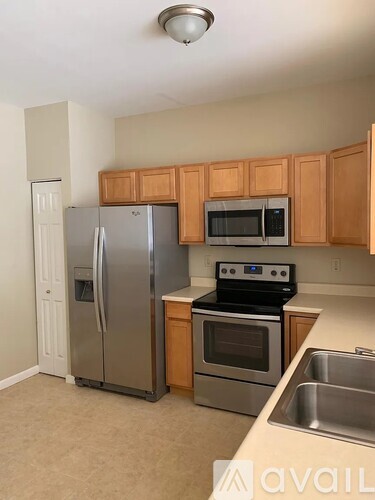 A kitchen with wooden cabinets and stainless steel appliances.