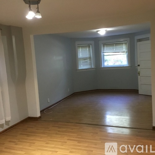 A room with wooden floors and a white door.