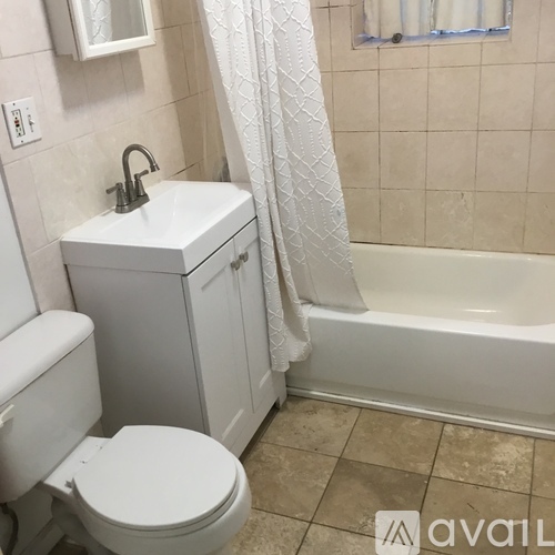 A white toilet and sink in a bathroom.