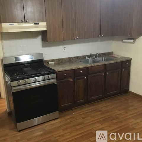 A kitchen with a stove and a sink.