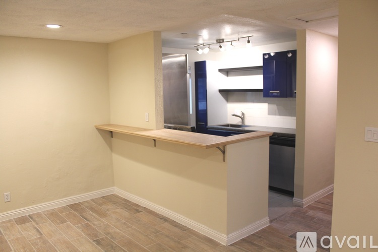 A kitchen with a countertop and a refrigerator.