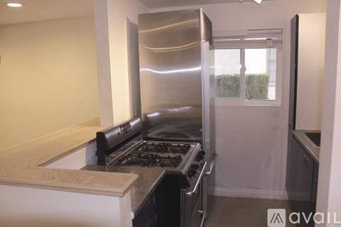 A modern kitchen with a stainless steel oven and range hood.