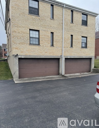 A two-story brick building with a garage door on the first floor.