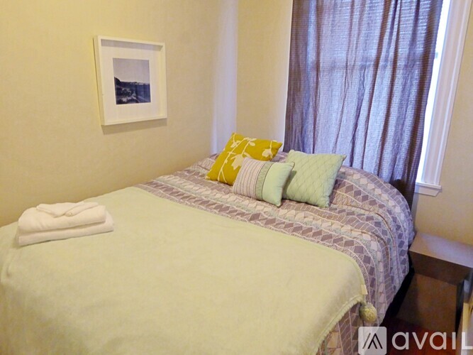 A bed with a white towel on top of it.