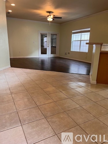 A room with tile flooring and a ceiling fan.
