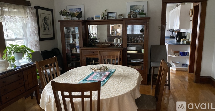 A dining room with a table set for a meal.