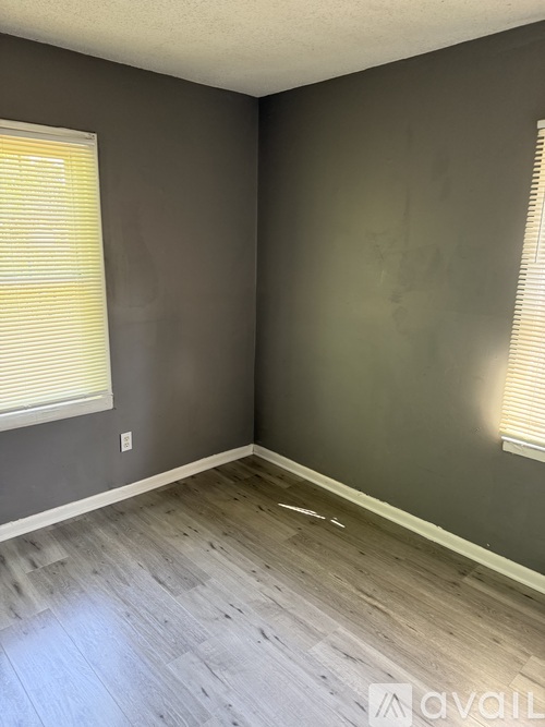 A room with grey walls and wooden flooring.