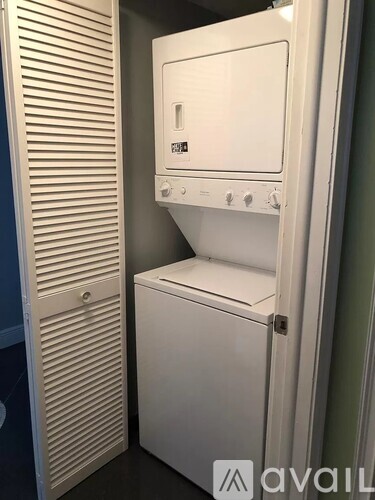 A white oven and microwave are installed in a kitchen.