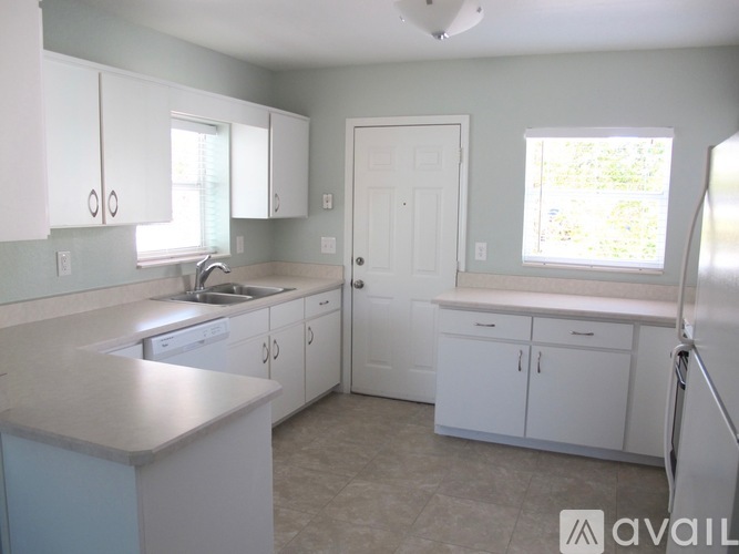 A kitchen with white cabinets and a countertop.