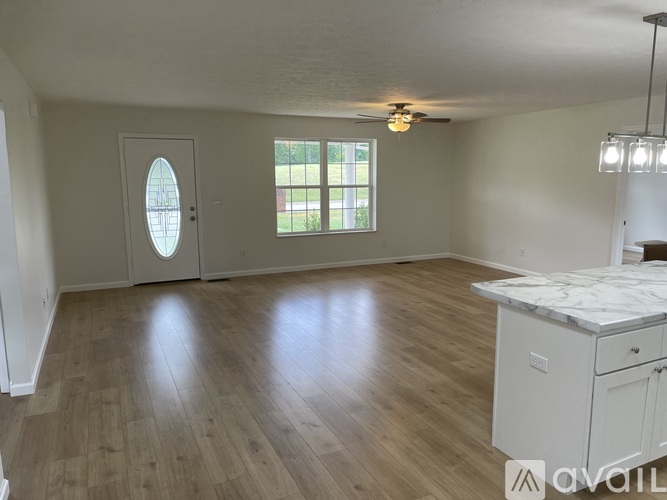 A spacious room with a window and a door.