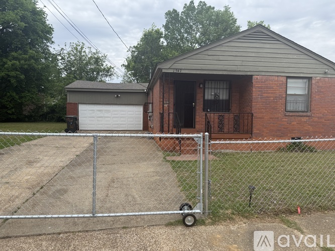 A house with a garage and a driveway in front.