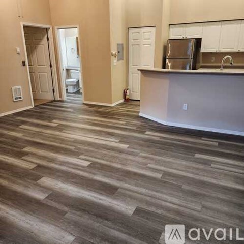 A kitchen area with a counter and cabinets.