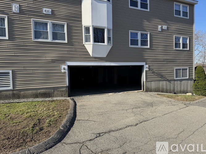 A building with a garage door and windows.