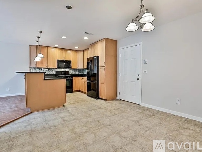 A kitchen area with a counter and cabinets is available.
