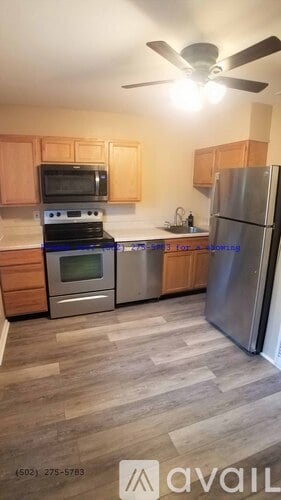 A kitchen with a stove, oven, microwave, and refrigerator.