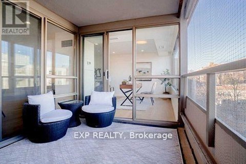 A balcony with chairs and a table is visible.