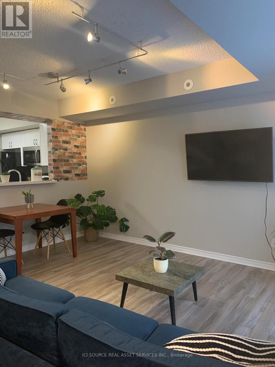 A living room with a grey couch and a wooden table.