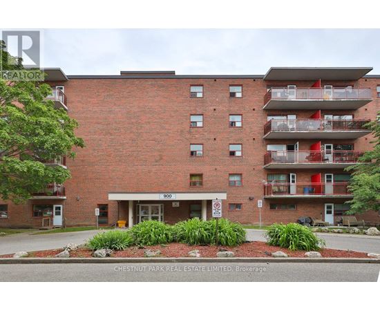 A red brick building with a white entrance and a sign that says 900.