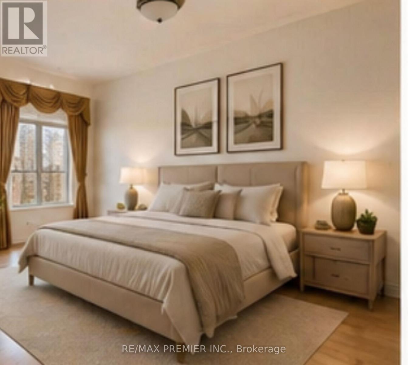 A bedroom with a large bed, two nightstands, and pictures on the wall.