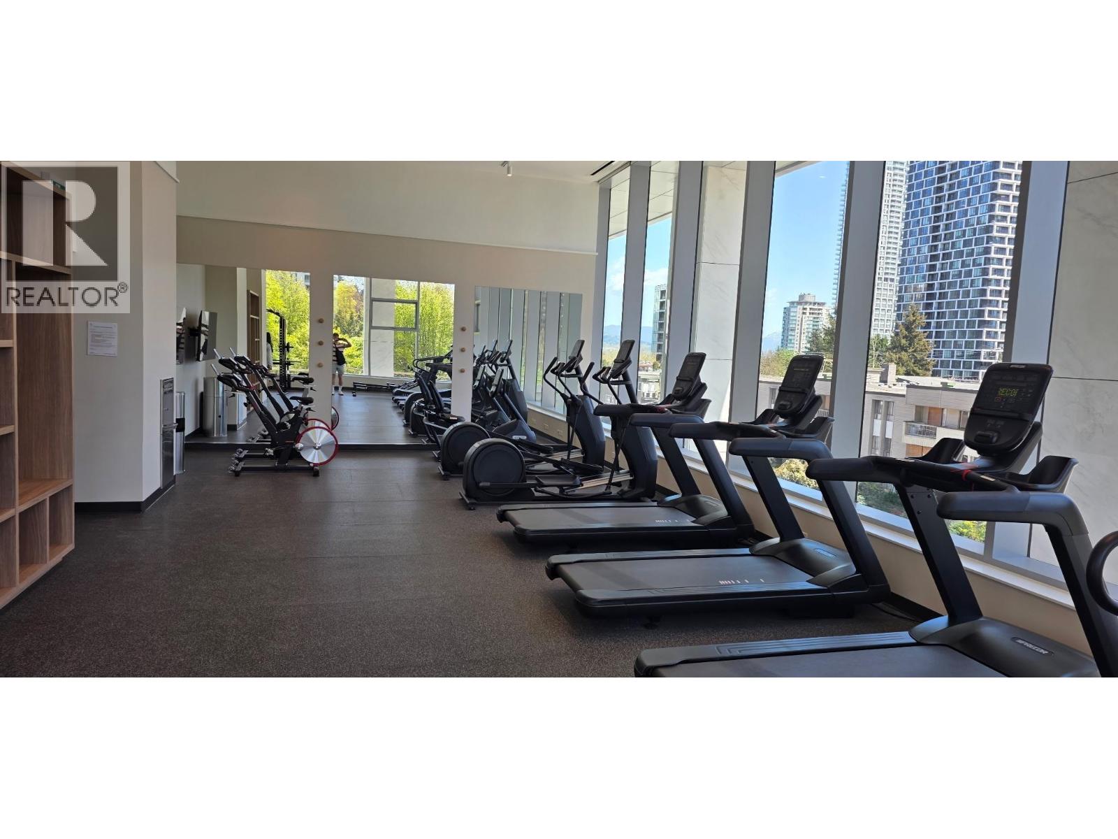 A gym with treadmills and elliptical machines.