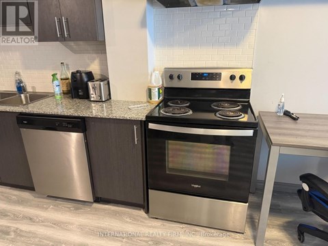 A modern kitchen with a stainless steel oven and microwave.