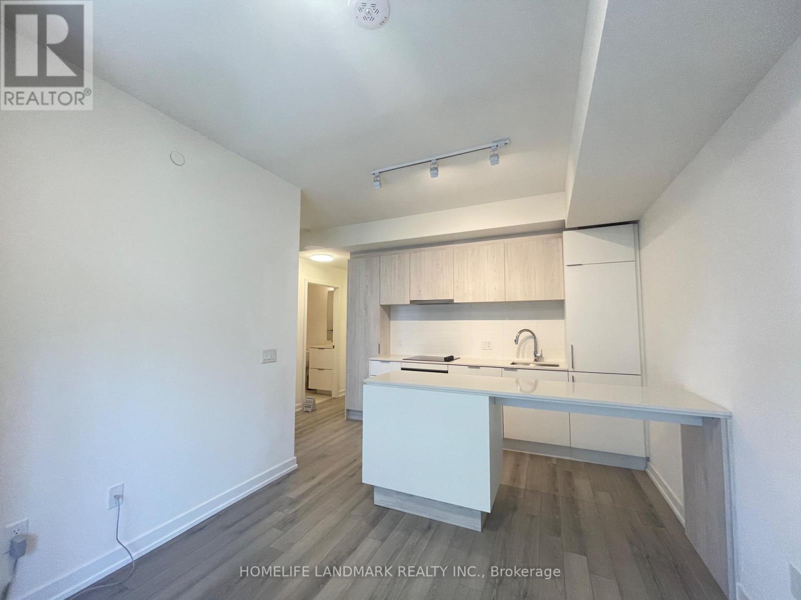 A white kitchen with a sink and cabinets.