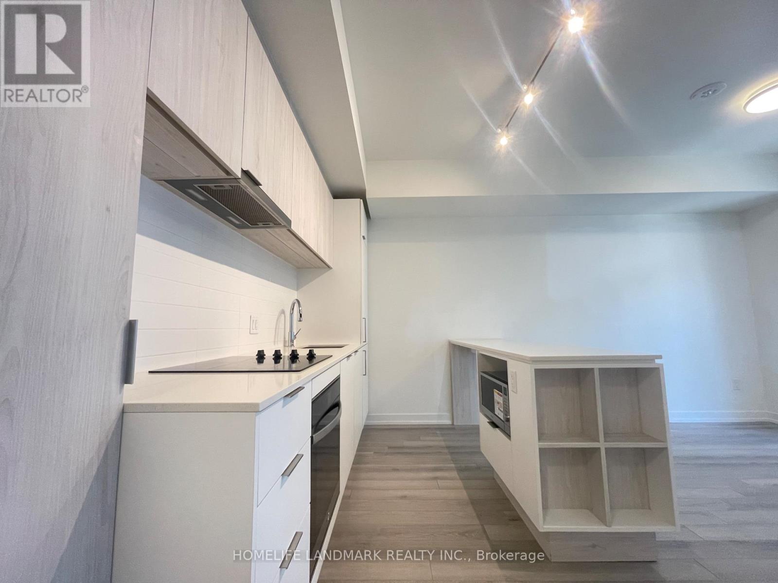 A kitchen with white cabinets and a countertop is shown.
