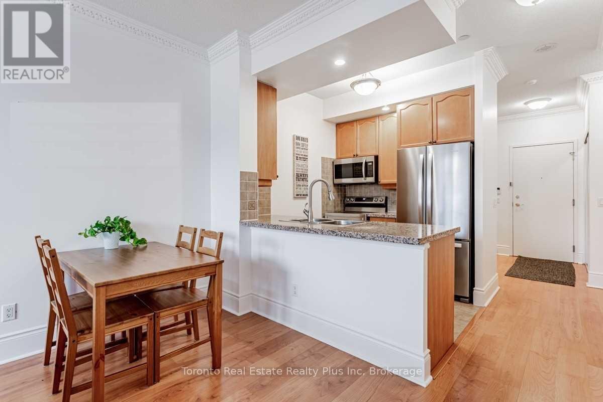 A kitchen with wooden cabinets and a countertop with a refrigerator and microwave.