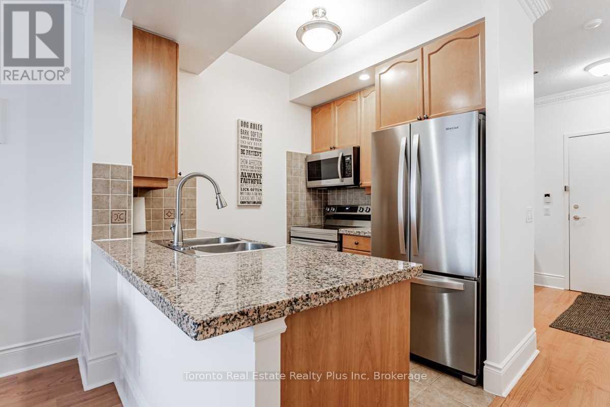 A kitchen with granite countertops and stainless steel appliances.
