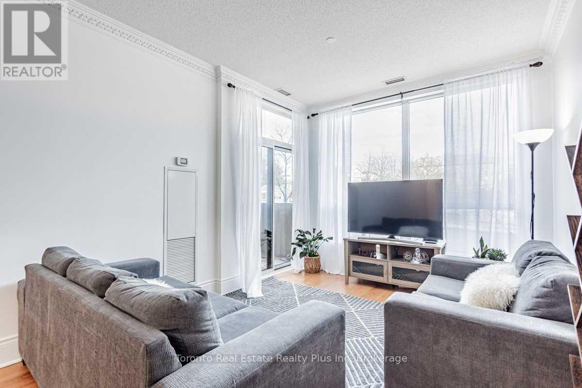 A living room with a grey couch and a television.