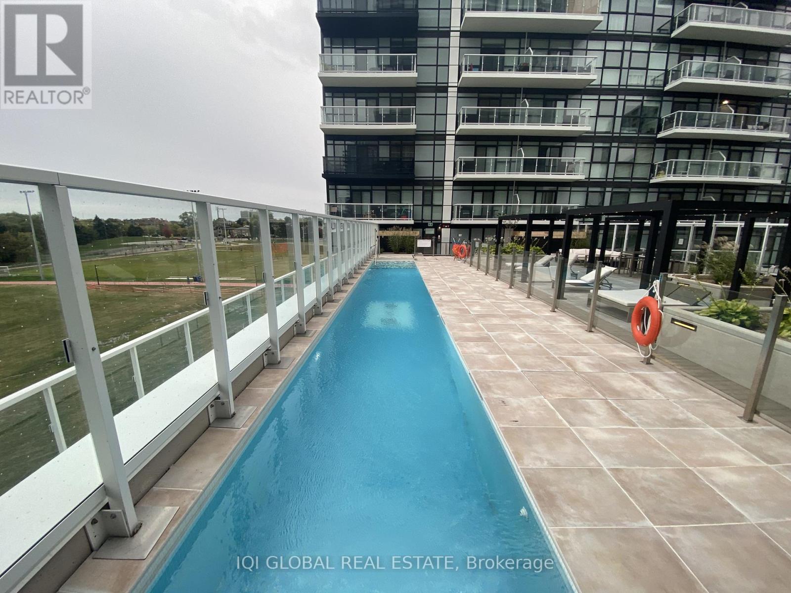 A long blue pool in a residential building.
