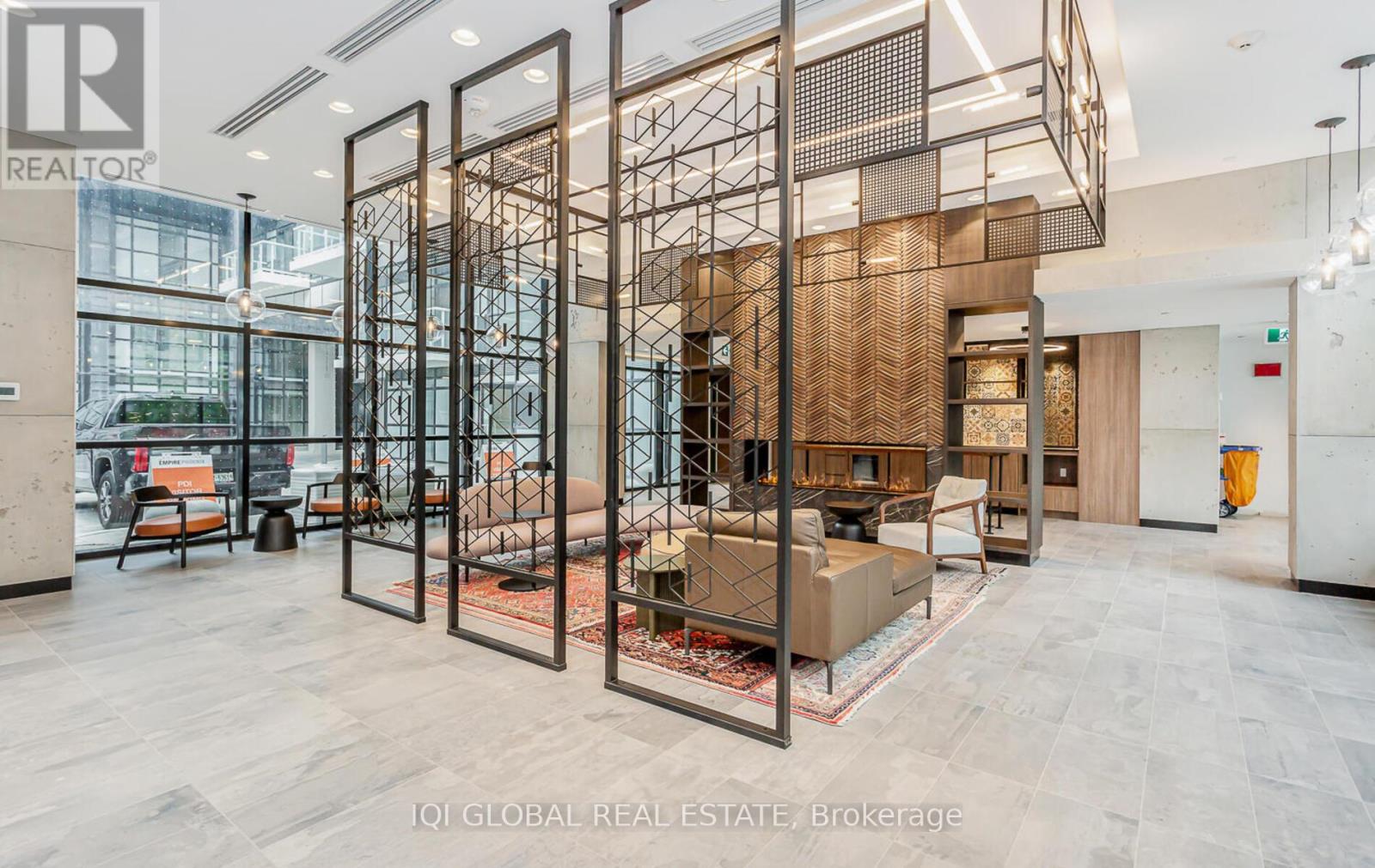 A modern interior space with a glass partition and a seating area.