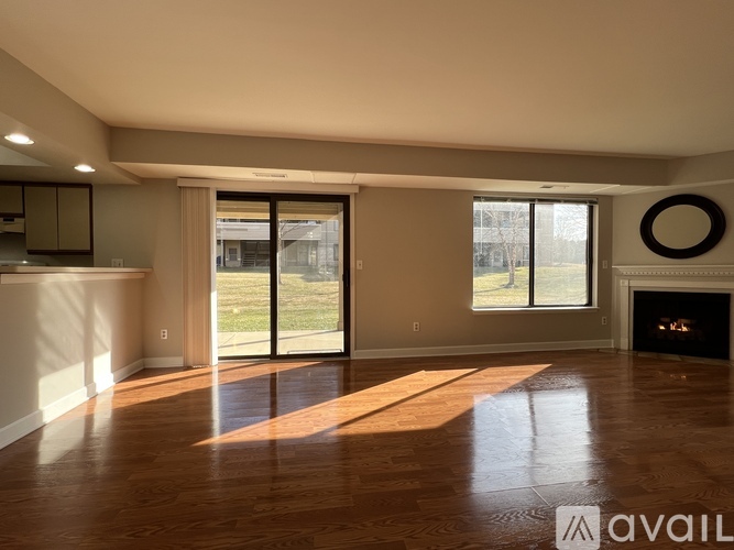 A spacious living room with a fireplace and sliding glass doors.