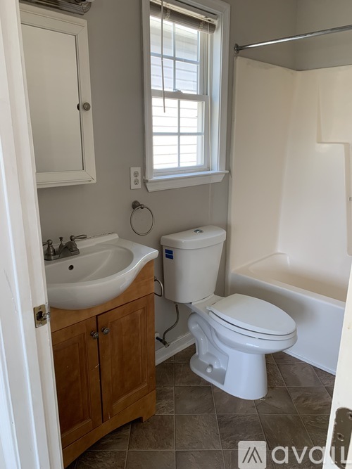 A white toilet sits next to a sink in a bathroom.