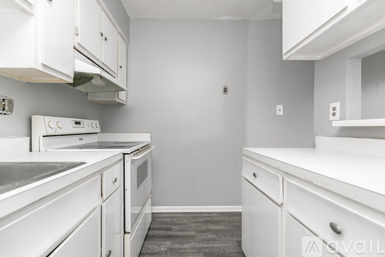 A kitchen with white cabinets and appliances.