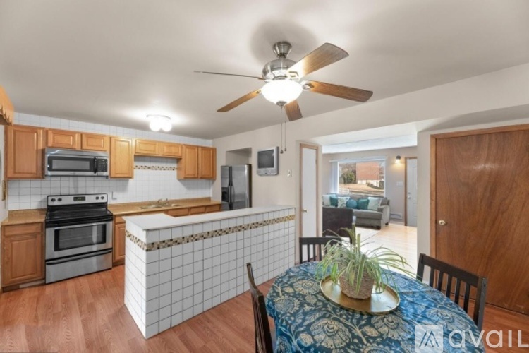 A kitchen with a table and chairs in the foreground.