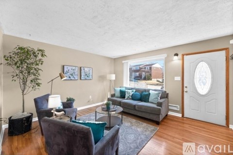 A living room with a grey couch and a coffee table.