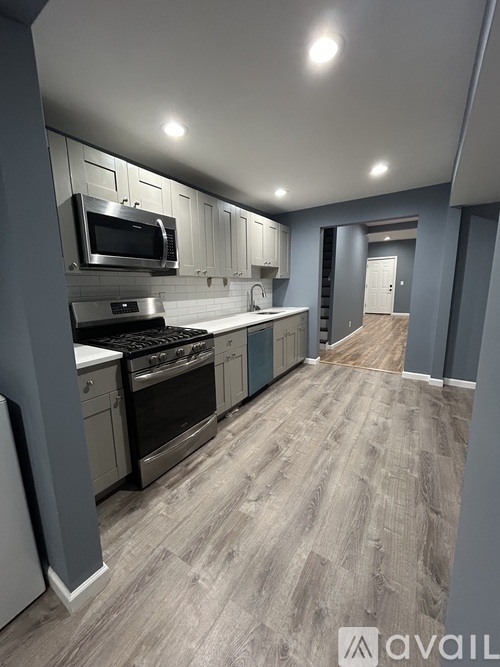 A kitchen with a stove top oven and microwave.