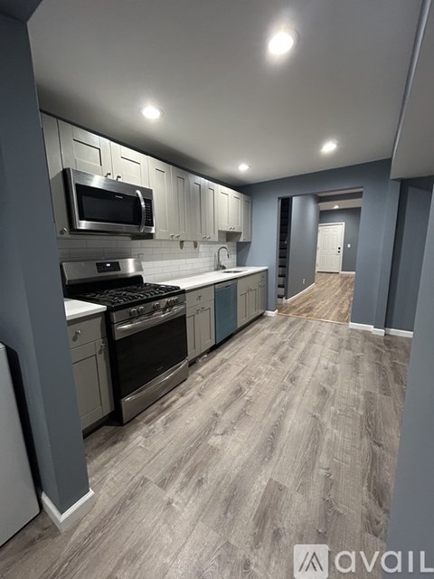 A kitchen with a stove top oven and microwave.